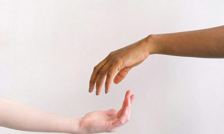 Two hands reaching toward each other